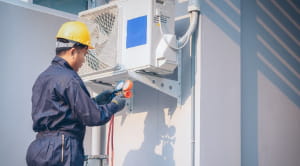 man installing heat pump